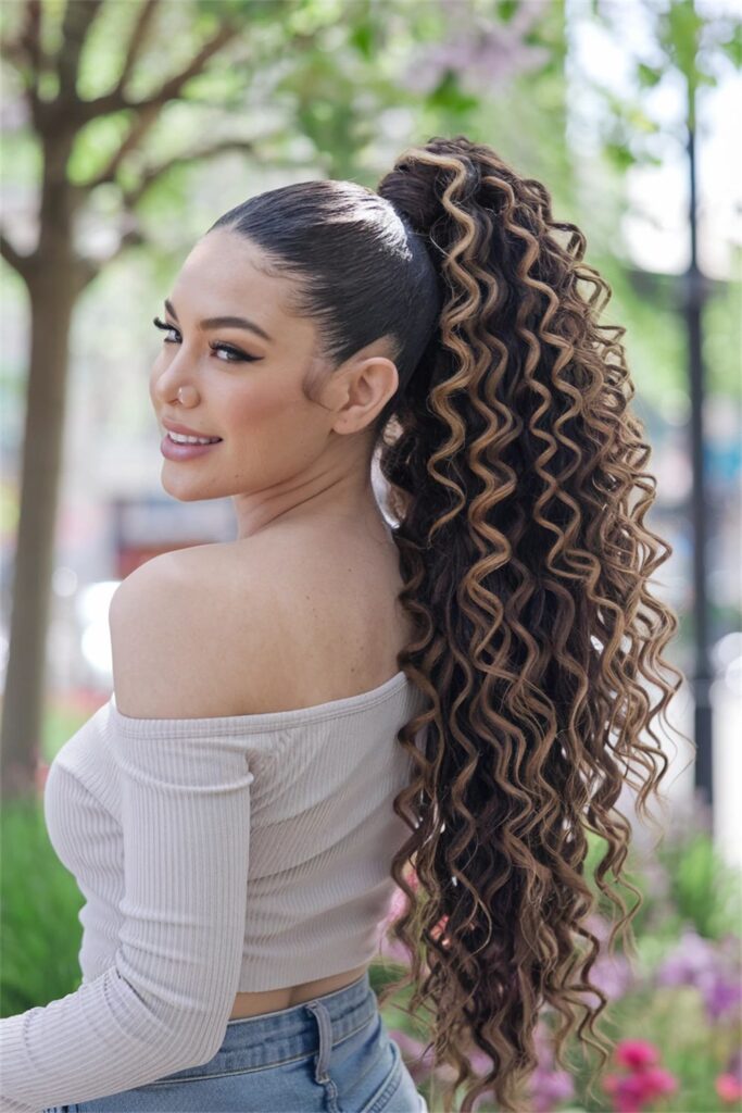 curly high pony with braid wrap