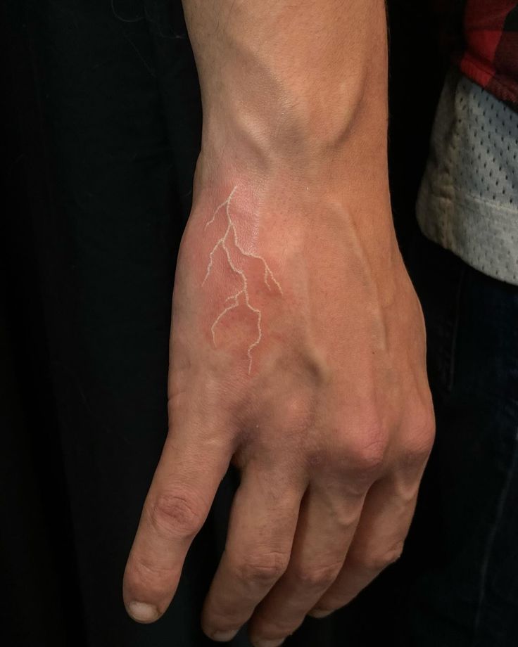 white ink hand tattoo