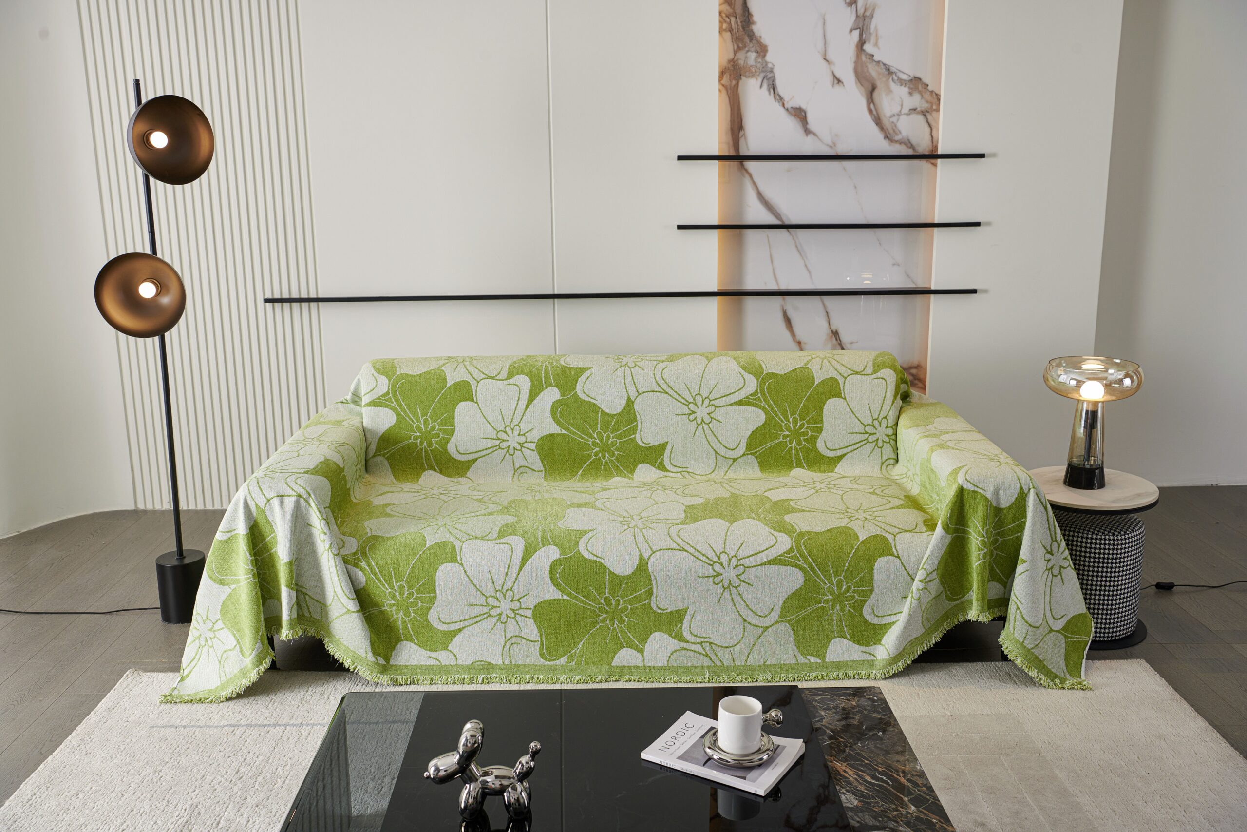 Light sofa with a beige throw draped over it in a bright living room