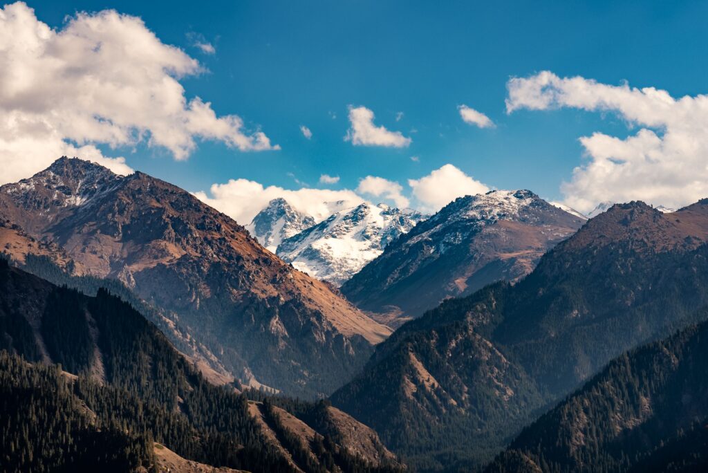 Beautiful view of the Tian Shan mountains in Xinjiang, China, under a bright blue sky.